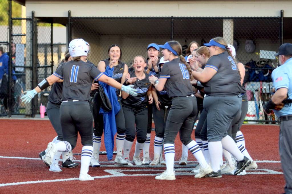 RYAN SPARKS | THE DAILY WORLD Rochesters Leah Hartley (11) celebrates with her teammates after hitting a game-tying home run in a 7-6 loss to Montesano on Thursday at Montesano High School.