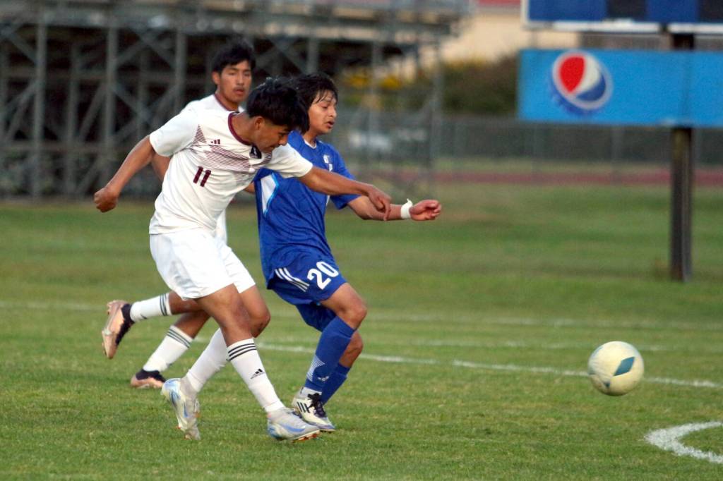 RYAN SPARKS | THE DAILY WORLD Raymond-South Bends Edgar Ramirez (11) gets off a shot while defended by Elmas Diego Morales on Tuesday in Elma.