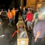 Don Holmes
A hastily organized working party unloads and moves a 1,700-pound parcel containing a new silver screen for the D&R Theatre in Aberdeen.