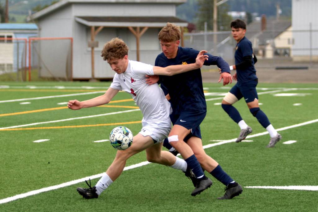 RYAN SPARKS | THE DAILY WORLD Aberdeen defender Ryker Scott (right) competes with R.A. Longs Liam Hendrickson during the Bobcats 2-1 loss in a 2A District 4 Tournament game on Saturday at Stewart Field in Aberdeen.