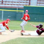 RYAN SPARKS / THE DAILY WORLD Montesanos Colton Grubb (14) attempts to steal a base against Castle Rock shortstop Brady Hamer (left) during a 6-0 victory in a 1A District 4 Tournament game on Monday at Olympic Stadium in Hoquiam.