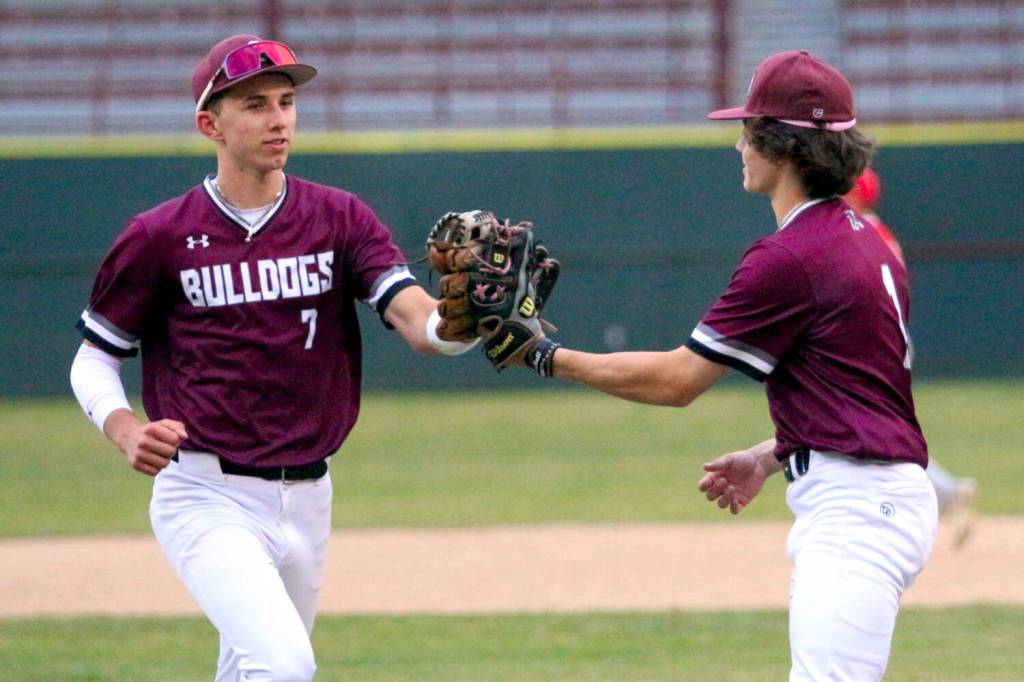 RYAN SPARKS / THE DAILY WORLD Montesano center fielder Tyson Perry (left) is congratulated by pitcher Kolson Hendrickson after making a diving catch in the sixth inning of a 6-0 win over Castle Rock on Monday in Hoquiam.