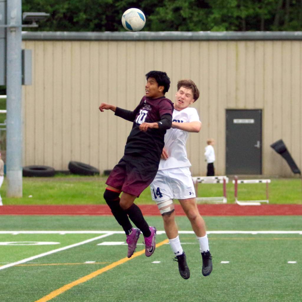 RYAN SPARKS | THE DAILY WORLD Raymond-South Bends Adam Mora (10) heads the ball against Seton Catholics Easton Ross during a 1A District 4 semifinal game on Tuesday at South Bend High School.