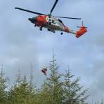 Grays Harbor Fire Department photos
A Coast Guard helicopter on Tuesday pulls a trapped worker out of a water tank under construction in Taholah.