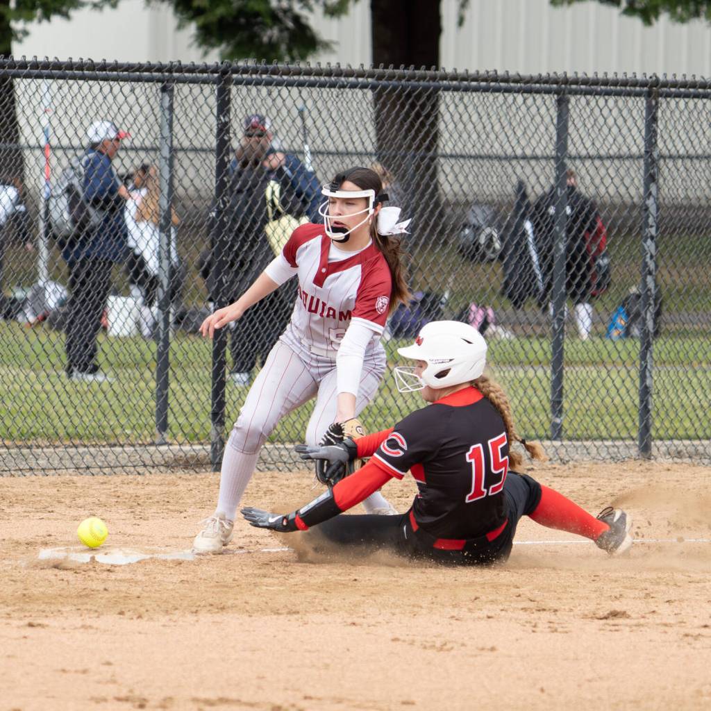 NICOLE SHANNON | THE CHRONICLE Hoquiam infielder Lexi LaBounty (left) attempts to record an out against Columbia-White Salmons Julia Mullinix during a district-tournament game on Wednesday in Centralia.