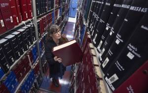 Ellen M. Banner / The Seattle Times
Danielle Miller, director at Washington Talking Book & Braille Library, pulls one of the approximately 25,000 Braille books off the librarys shelves in Seattle. State budget cuts could cause the library to close.