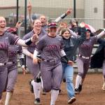 PHOTO BY HAILEY BLANCAS Montesanos Grace Gooding (5), Kennedy Campbell (12) and their teammates rejoice after winning the programs third-straight district title on Thursday in Centralia.