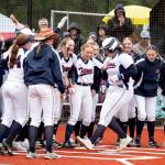 NICOLE SHANNON | MAIN FOCUS MEDIA Pe Ell-Willapa Valleys Sophia Milanowski is greeted by her teammates after hitting a home run in the 2B District 4 championship game on Thursday in Centralia.