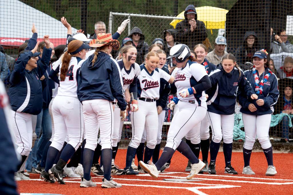 NICOLE SHANNON | MAIN FOCUS MEDIA Pe Ell-Willapa Valleys Sophia Milanowski is greeted by her teammates after hitting a home run in the 2B District 4 championship game on Thursday in Centralia.