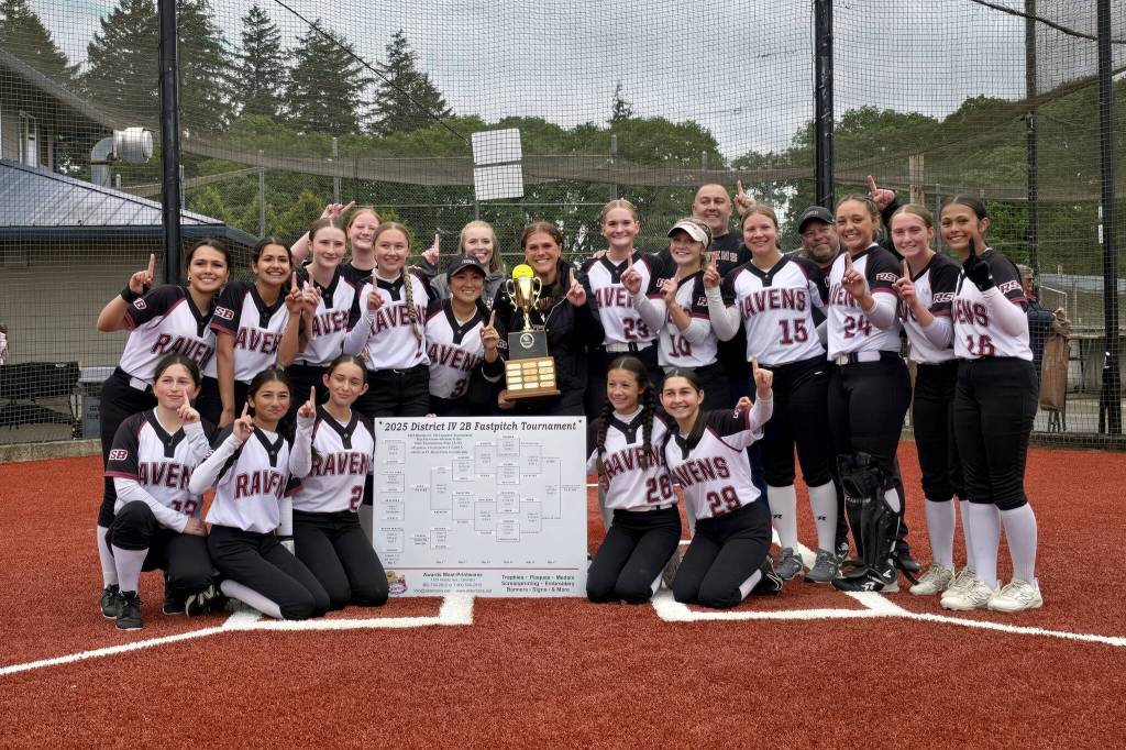 RYAN SPARKS | THE DAILY WORLD The Raymond-South Bend Ravens pose for a team photo after winning the 2B District 4 championship on Friday at Fort Borst Park in Centralia.