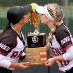 RYAN SPARKS | THE DAILY WORLD Raymond-South Bends Berklee Morley (left) and Emma Glazier kiss the 2B District 4 championship trophy on Friday at Fort Borst Park in Centralia.
