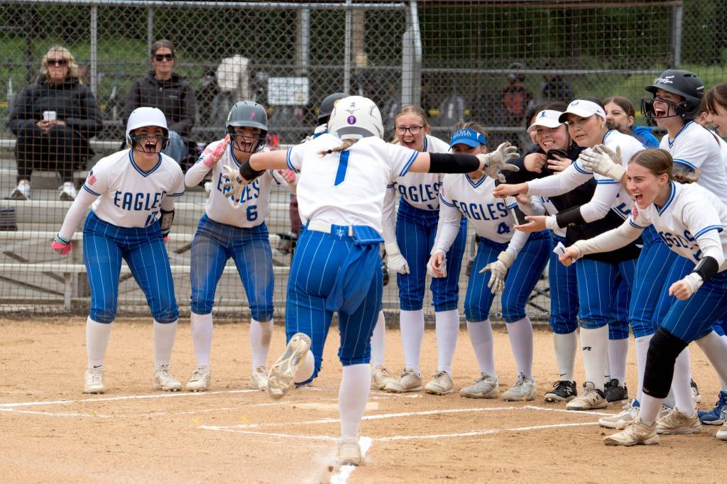 NICOLE SHANNON | MAIN FOCUS MEDIA Elmas Ashlynn Weld (1) is greeted by her teammates after hitting a Grand Slam home run during a 10-7 win over Lynden Christian in the 1A District 1/4 Tournament on Thursday in Centralia.