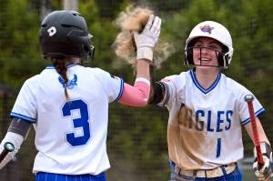 CHRYSTAL WELD PHOTOGRAPHY Elmas Ashlynn Weld (1) receives a high-five from Emily Comer during the 1A District 1/4 Tournament on Thursday in Centralia.