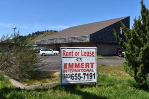Jerry Knaak photos / The Daily World
A car adorned with placards for Jerry Reeves business sits outside this former machinists union lodge (LL W130) building that Terry Emmert purchased for $339,000 in 2021. The car has been parked on the property for months.