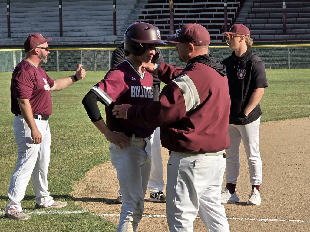 RYAN SPARKS | THE DAILY WORLD
Montesano head coach Mike Osgood (right) consoles senior Dennis Churchill after the Bulldogs suffered a season-ending loss to Overlake/Bear Creek in a 1A State quarterfinal game on Saturday in Hoquiam.