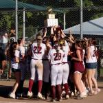 PHOTO BY HAILEY BLANCAS The Montesano Bulldogs raise the 1A State Championship trophy after defeating Rochester 10-5 on Saturday at the Columbia Playfields in Richland.