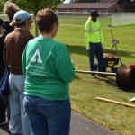 Jerry Knaak / The Daily World
Jose Hernandez (white helmet) and Caesear Valdivia of Castaneda Landscaping Company demonstrate the proper way to plant a tree.