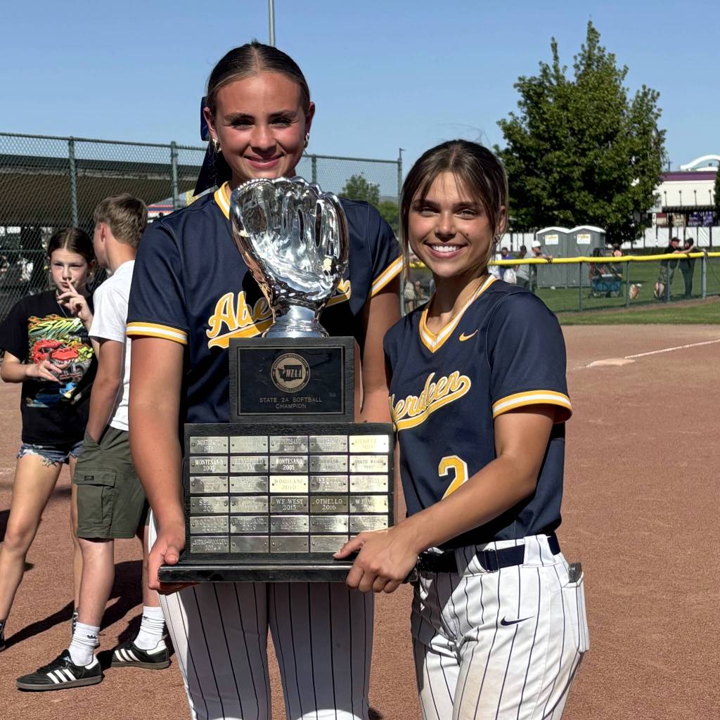 SUBMITTED PHOTO The Aberdeen battery of pitcher Lilly Camp (left) and catcher Alyssa Yakovich hold the 2A State Championship trophy after beating Port Angeles 2-1 in the title game on May 24 in Selah.