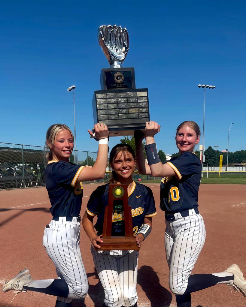 SUBMITTED PHOTO Aberdeen players (from left) Rylee Hendrickson, Alyssa Yakovich and Britten Neal were all smiles while taking photos with the 2A State Championship trophy on May 24 in Selah.