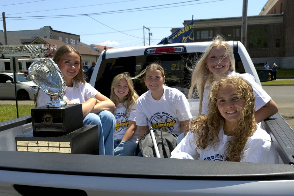 RYAN SPARKS | THE DAILY WORLD Aberdeen senior softball players (from left) Lilly Camp, Kadence Braaten, Abby Mainio, Zoe Vessey and Scotlyn Lecomte prepare for the beginning of a parade and celebration in honor of the teams state championship.