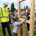 A young Robert Gray elementary School student tries their hand at construction.