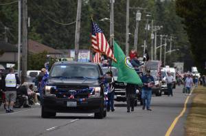 Jerry Knaak photos / The Daily World
The Ocean Shores Flag Day Parade gets underway with the chief of police leading the way.