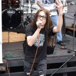 Clear Nothings lead singer Scott Cokeley sings for the crowd in the mosh pit in front of the I Street stage on World Music Day.