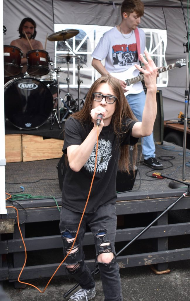 Clear Nothings lead singer Scott Cokeley sings for the crowd in the mosh pit in front of the I Street stage on World Music Day.