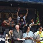 Front from left: Jessie Preston of Indiegroove Records, Grays Harbor County Commissioner Rick Hole, Aberdeen City Admnistrator Ruth Clemens and Executive Director of the Downtown Aberdeen Association Wil Russoul participate in a gift exchange with One Way Sky.