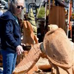 Ruth Arkless / For The Daily World
A Sand and Sawdust festival goer checks out a chainsaw sculpture.