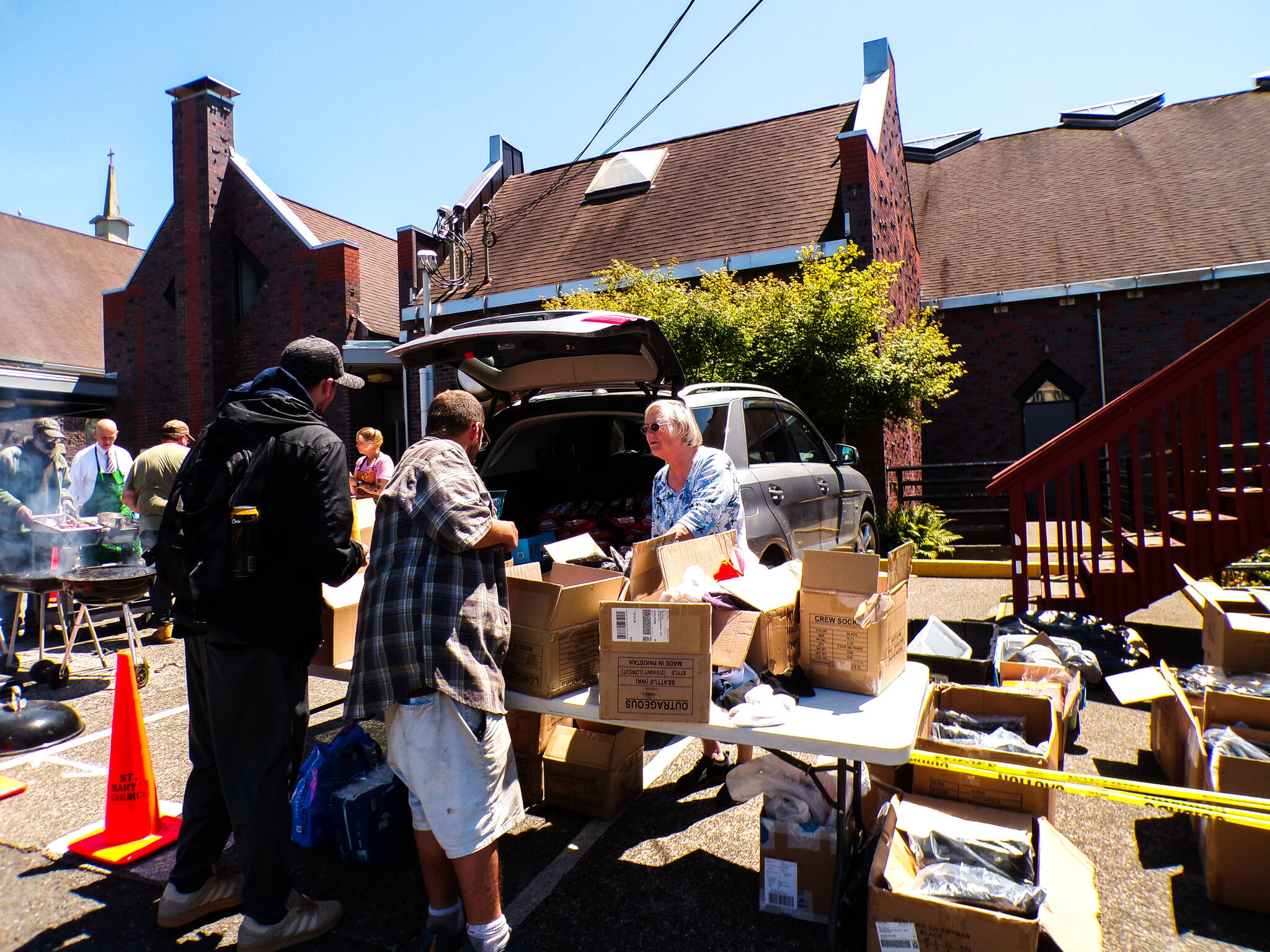 A volunteer hands out meals on the Feed the Hungry programs last day. (Kyndra Burkland / For The Daily World)