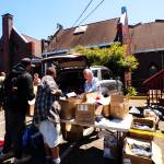 A volunteer hands out meals on the Feed the Hungry programs last day. (Kyndra Burkland / For The Daily World)