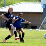 PHOTO BY LORI VALENTINE A player from the Grays Harbor Gulls Blue team (left) battles for possession against a player from the Elma McCleary Football Club during a girls 11 and under match at the Coastal Cup on Saturday in Aberdeen.