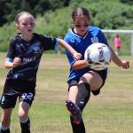 PHOTO BY LORI VALENTINE A player from the Grays Harbor Gulls Blue team (left) battles for possession against a player from the Elma McCleary Football Club during a girls 11 and under match at the Coastal Cup on Saturday in Aberdeen.