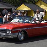 McCleary Bear Festival Grand Marshal April Wright waves to the crowd from a classic Buick.