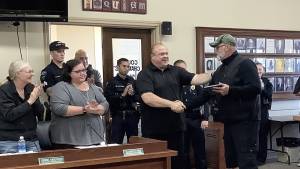 Hoquiam Mayor Ben Winkelman congratulates Hoquiam Police Officer James Gaddis who is retiring after 24 years of service. (Hoquiam Police Department)