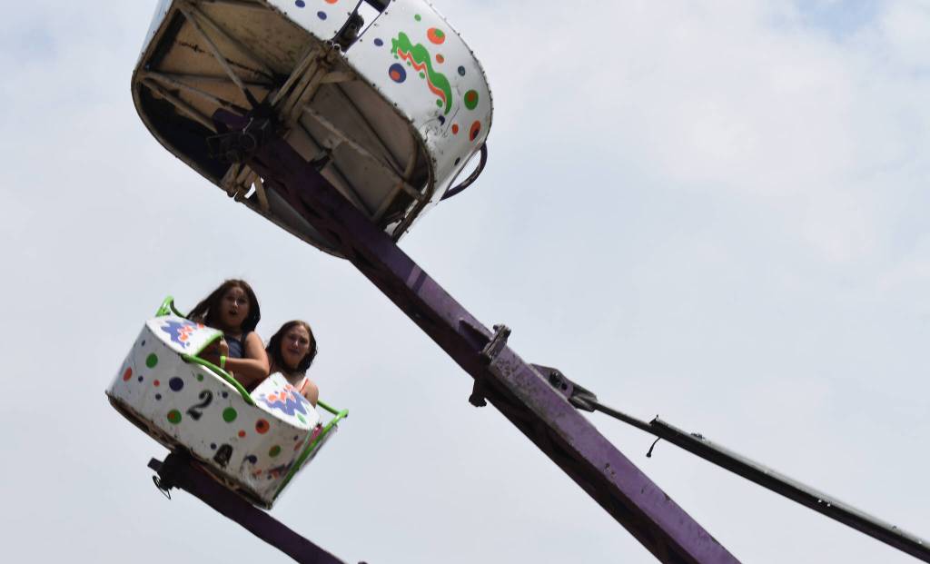 A pair of fairgoers get airborne on a ride.
