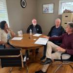 Congresswoman Emily Randall visits with NeighborWorks of Grays Harbors Board President Bill Sidor, Board 2nd Vice President Ty Palmer and Executive Director Eric Bjella.
