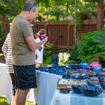 A person browses Miriam Storms wheel-thrown pottery.