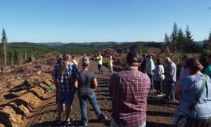 Andrea Watts / The Daily World
On the city of Montesano City Forest Tour held on July 15, attendees visited a site that had been recently harvested. In the distance are slash piles, comprised of treetops and branches. These parts of the tree dont have marketable value and are considered forest biomass, which could be a potential source for use as bioenergy.