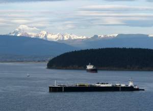 Tom Banse photos / Washington State Standard
The articulated tug barge in the foreground at anchor near Anacortes is a prime example of the oil and diesel fuel transport vessel class getting more attention from state regulators.