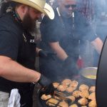 The next batch of chicken hits the grill.