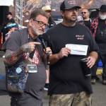 Media personality Rick Moyer hands the grand prize in the BBQ tasting competition to Vitamin Q.