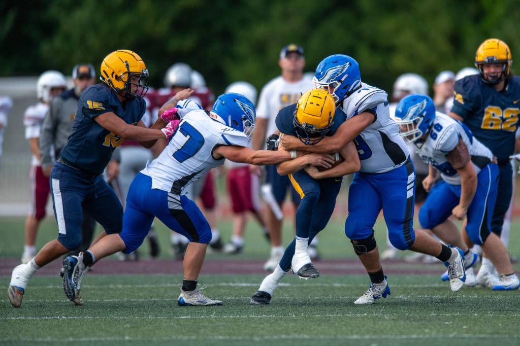 PHOTO BY FOREST WORGUM The Elma Eagles (blue/white) defend against the Forks Spartans during the Montesano Jamboree on Friday at Jack Rottle Field in Montesano.