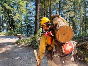 Bear Gulch Fire 2025
A firefighter moves hazard fuel while working on the Bear Gulch fire this summer. Many in the wildland fire community believe the leadership team managing the fire sent crews into an ambush by federal immigration agents.