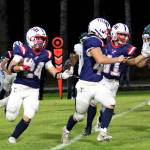 RYAN SPARKS | THE DAILY WORLD Pe Ell-Willapa Valleys Lucas Lusk (24) followed the blocks of Spud Swogger (middle) and Hank Swartz (right) during the Titans 41-8 win over Evergreen (Seattle) on Friday at Crogstad Field in Menlo.