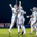 PHOTO BY FOREST WORGUM Montesanos Isac Hawkins (9) and Zach Timmons (4) celebrate with Mason Fry (8) after a blocked field goal secured a 20-19 win over La Center on Friday at La Center High School.
