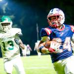 PHOTO BY MATT RUMBLES Pe Ell-Willapa Valley running back Lucas Lusk (24) sprints away from Evergreens Jay Reese during the Titans 41-8 win on Friday at Willapa Valley High School.