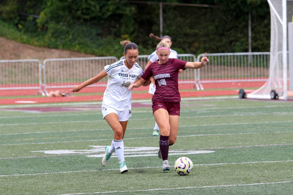 RYAN SPARKS | THE DAILY WORLD Montesanos Olivia Reynvaan (right) dribbles away from Cedar Park Christians Brynna Balkcum during the Bulldogs 3-0 loss on Saturday in Montesano.