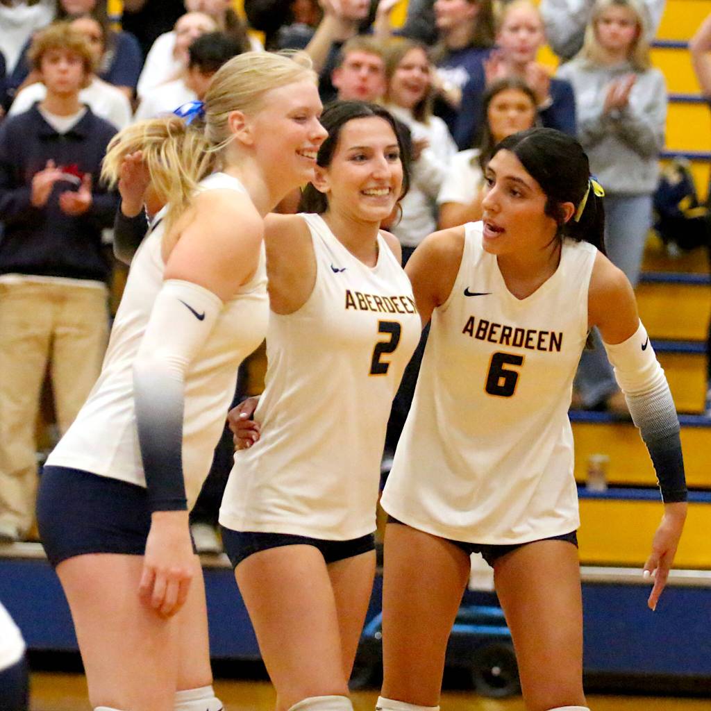 RYAN SPARKS | THE DAILY WORLD Aberdeens Dallyn Williams (left), Micah Turpin (2) and Mia Hallak celebrate a point during a win over Hoquiam on Thursday at Sam Benn Gym in Aberdeen.